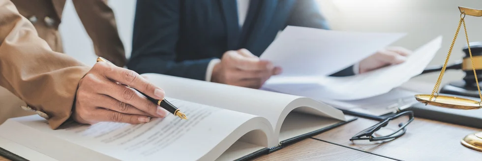 Legal professionals reviewing contracts and documents in a law office