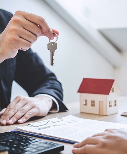 Estate planning attorney handing over house keys in Tampa, FL