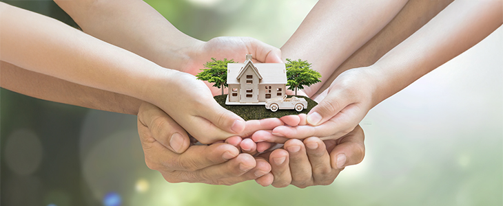 A couple's hands holding a house and car, representing Florida Community Property and joint estate planning.