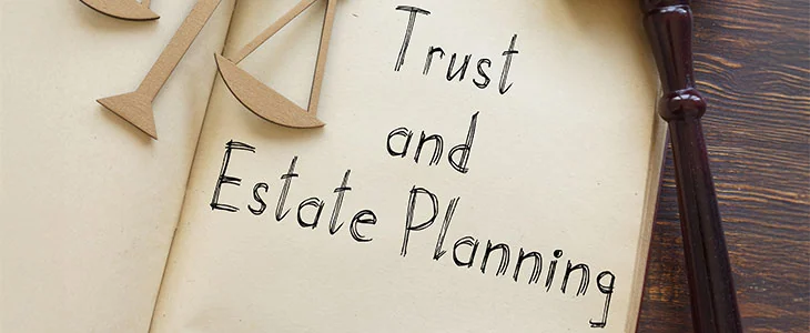 A gavel, scales of justice, and a document about trust and estate planning.